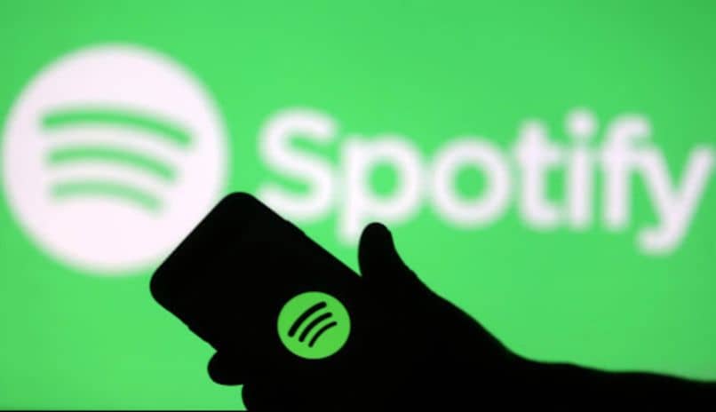 icono spotify verde silueta mano movil